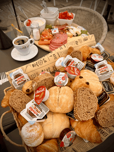 a basket of bread and pastries with nutella and biscoff on it