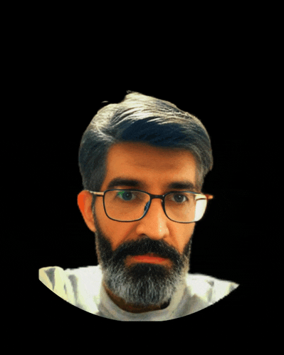 a man with glasses and a beard looks at the camera with a black background