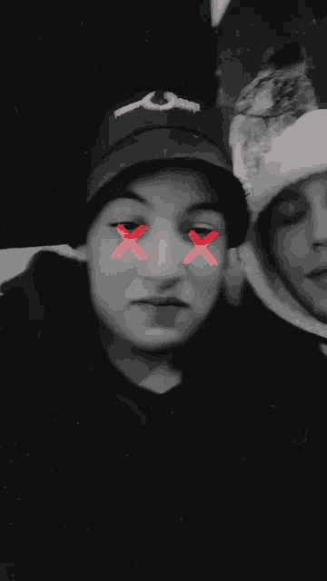 a blurry photo of two people with a red smiley face on their face