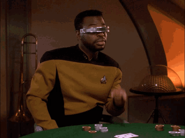a man wearing a star trek uniform playing poker