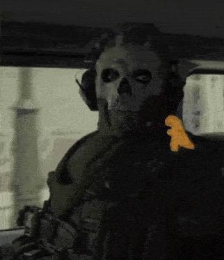 a man wearing a skull mask is sitting in a car with a chicken nugget on his shoulder .