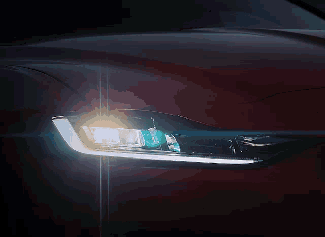 a close up of a car 's headlight that is shining brightly
