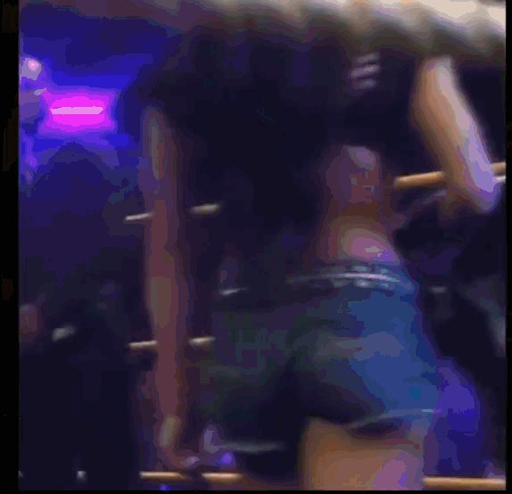 a woman is laying on the ground in a wrestling ring with her legs crossed