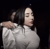 a woman in a white turtleneck sweater is being held by a man .
