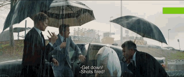 a group of men standing under umbrellas in the rain and one of them says get down shots fired