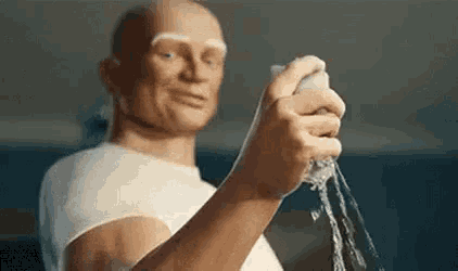a statue of a man is holding a sponge in his hand and pouring water on it .
