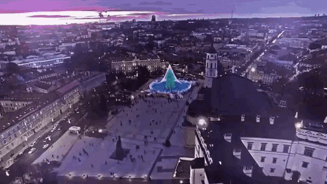 an aerial view of a city with a christmas tree in the center