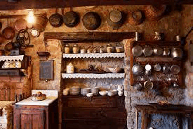 a kitchen with a lot of pots and pans on the wall .