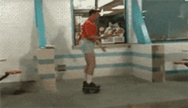 a man in shorts is rollerblading in a fast food restaurant