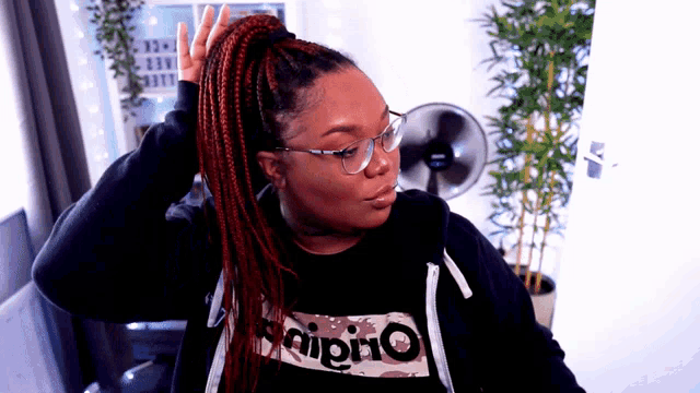a woman wearing a black shirt that says origino