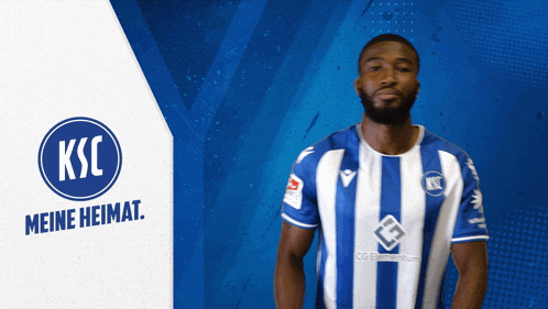 a man wearing a blue and white striped shirt with ksc meine heimat on the bottom