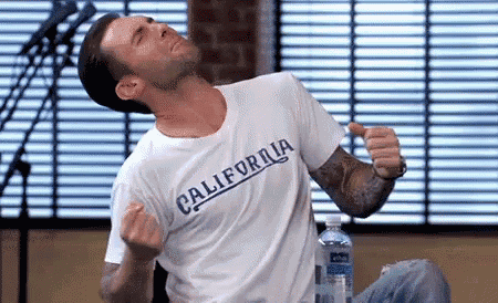 a man wearing a california t-shirt is giving the middle finger .