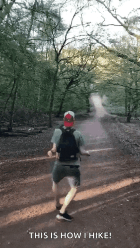 a man with a prosthetic leg is running down a dirt path with the words " this is how i hike " above him
