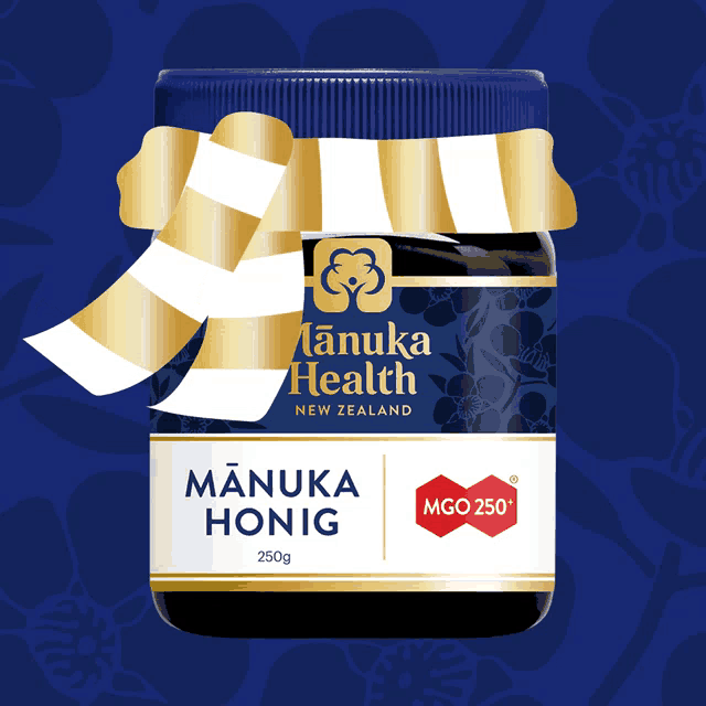 a jar of manuka honey from new zealand with a gold bow