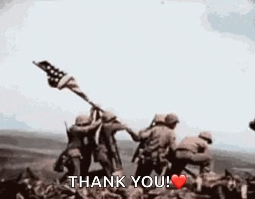 a group of soldiers are raising an american flag and saying thank you !