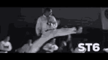 a black and white photo of a man doing karate with the words st6 in the corner