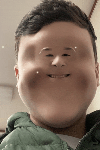 a boy with a very large face and a green jacket