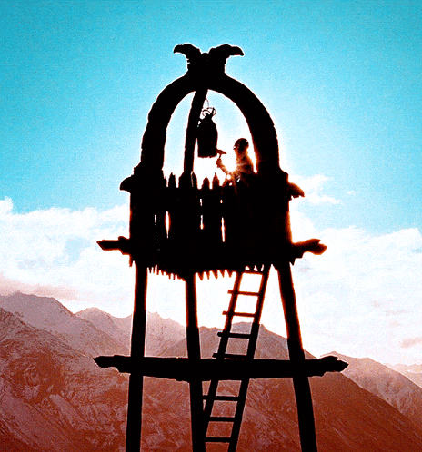 a silhouette of a tower with a ladder and a bell