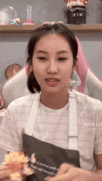 a girl wearing an apron with the word bigo on it