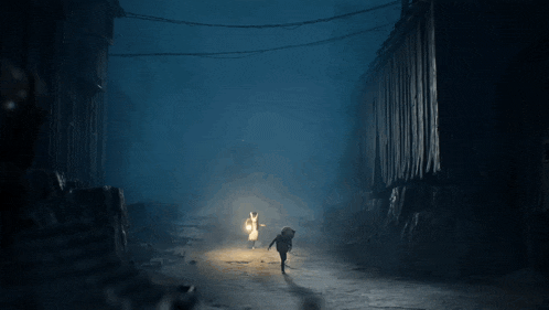 a man and a woman are walking in the dark with a flashlight