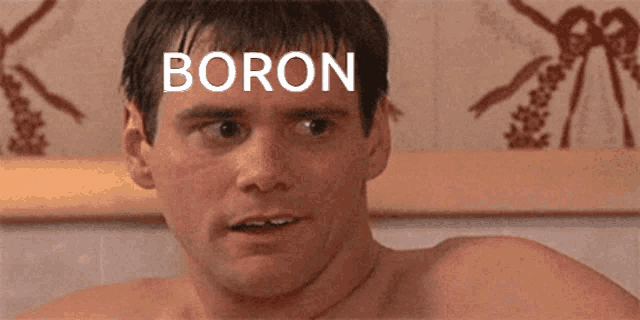 a man without a shirt has the word boron on his forehead