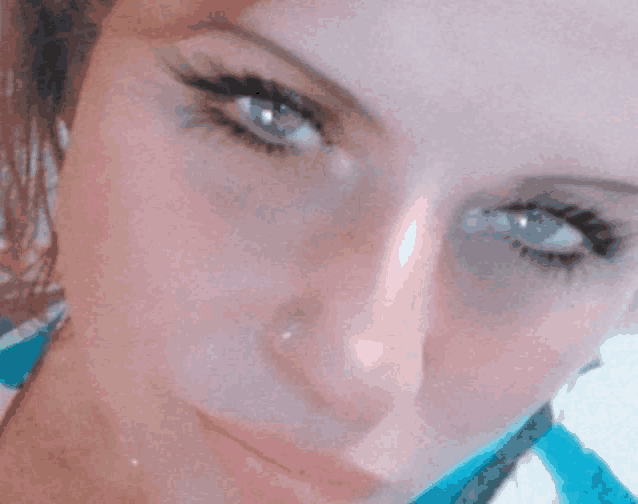 a close up of a woman 's face shows her blue eyes