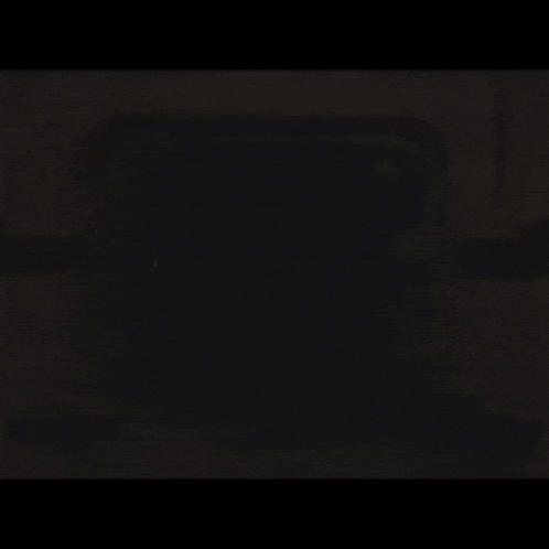 darth vader is holding a light saber in the dark