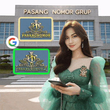 a woman in a green dress holding a cell phone in front of a building that says pasang nomor grup