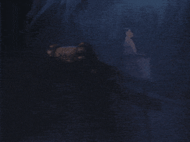 a dark cave with ice formations and a hand reaching out