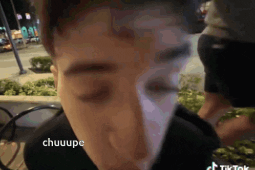 a close up of a person 's face with the word chuuupe written on it