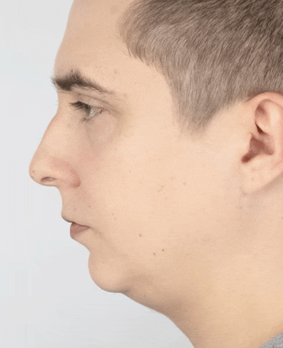 a close up of a man 's face with a gray background