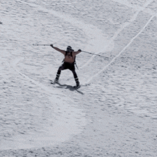 a man without a shirt is skiing down a snowy mountain