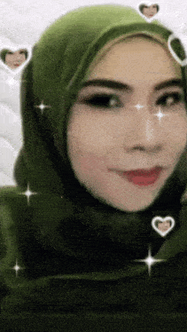 a woman wearing a green hijab is smiling with hearts around her face
