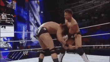 two men are wrestling in a wrestling ring and the words i love wrestling girls are on the bottom of the screen