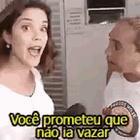 a man and a woman are talking to each other in a kitchen and the woman is talking to the man .