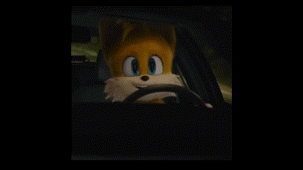 a stuffed fox is driving a car in the dark .