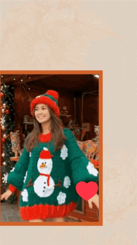 a woman is wearing a sweater with a snowman on it