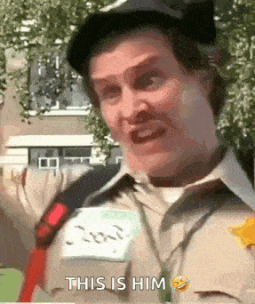 a man is wearing a hat and a name tag that says this is him on it .