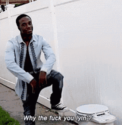 a man is standing next to a toilet and saying " why the fuck you lyin "