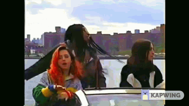 a group of people are riding in a boat on a body of water .