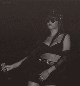 a black and white photo of a woman with sunglasses on