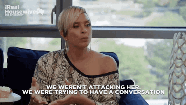 a woman sits on a couch with the words we weren 't attacking her