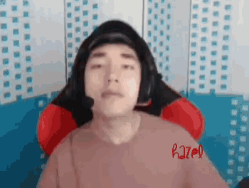 a man wearing headphones and a sweater with the word razer on it