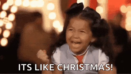 a little girl is laughing and saying `` its like christmas '' .