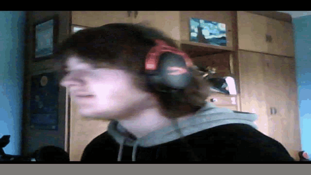 a man wearing headphones with a red band around his ear