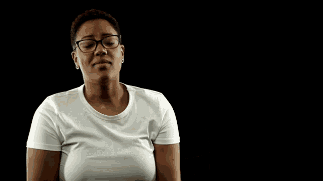 a woman wearing glasses and a white shirt