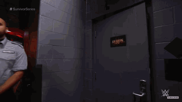 a man standing in a hallway with the words survivor series written on the bottom