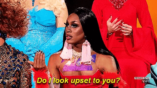 a woman in a red dress is talking to a group of women .
