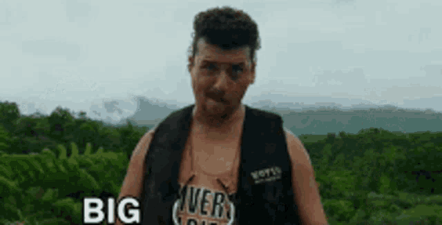 a man wearing a vest that says " big river "