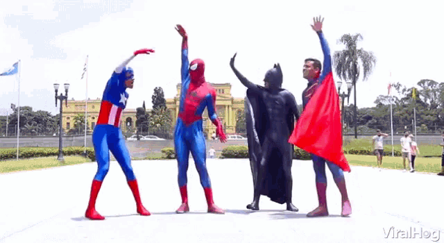 a group of superheros are posing for a picture together